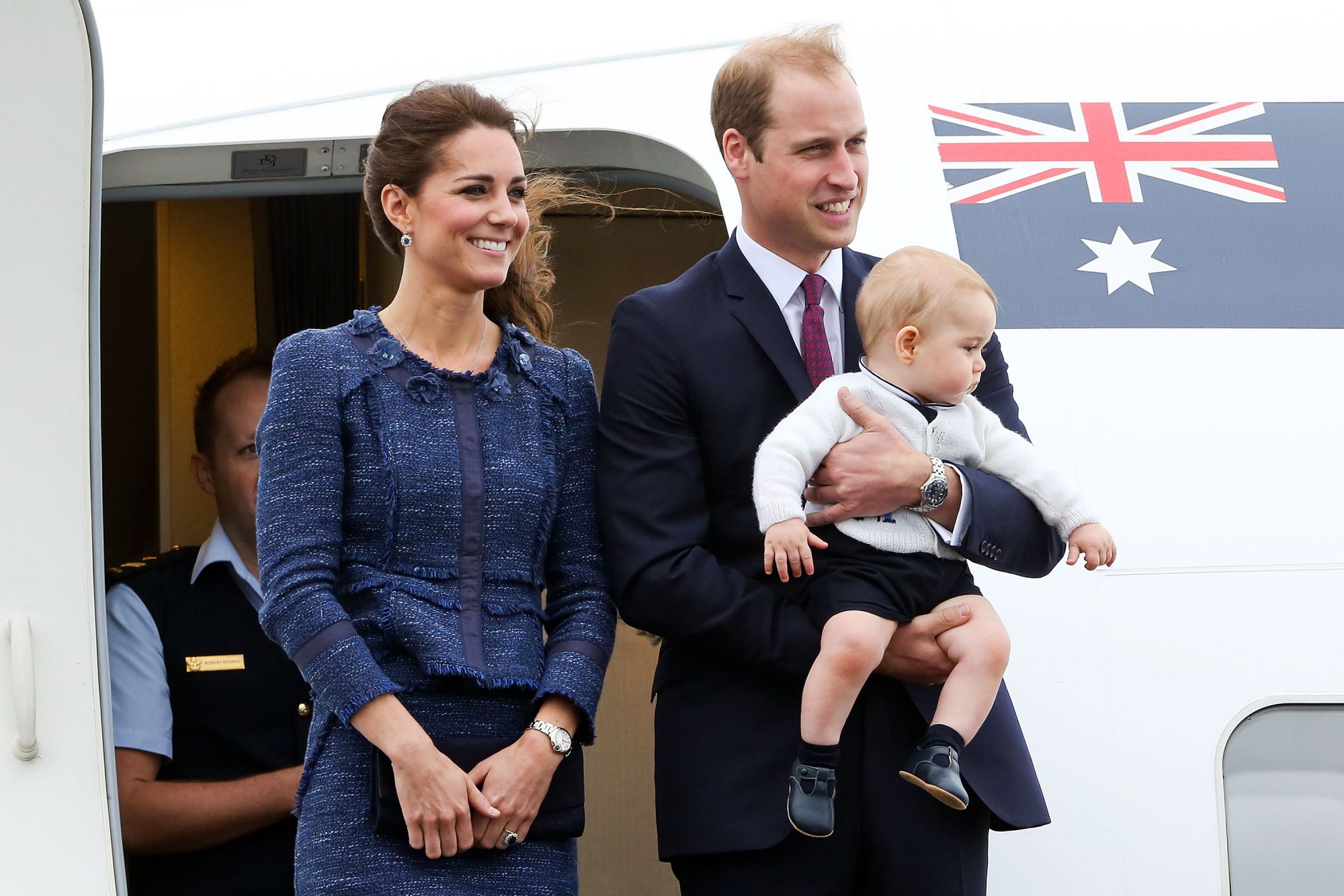WELLINGTON, NEW ZEALAND - APRIL 16:  Catherine, Duchess of Cambridge, Prince William, Duke of Cambridge and Prince George of Cambridge look on before boarding a Royal Australian Air Force plane for their flight to Australia at Wellington Airport's military terminal April 16, 2014 in Wellington, New Zealand. The Duke and Duchess of Cambridge are on a three-week tour of Australia and New Zealand, the first official trip overseas with their son, Prince George of Cambridge.  (Photo by Hagen Hopkins/Getty Images