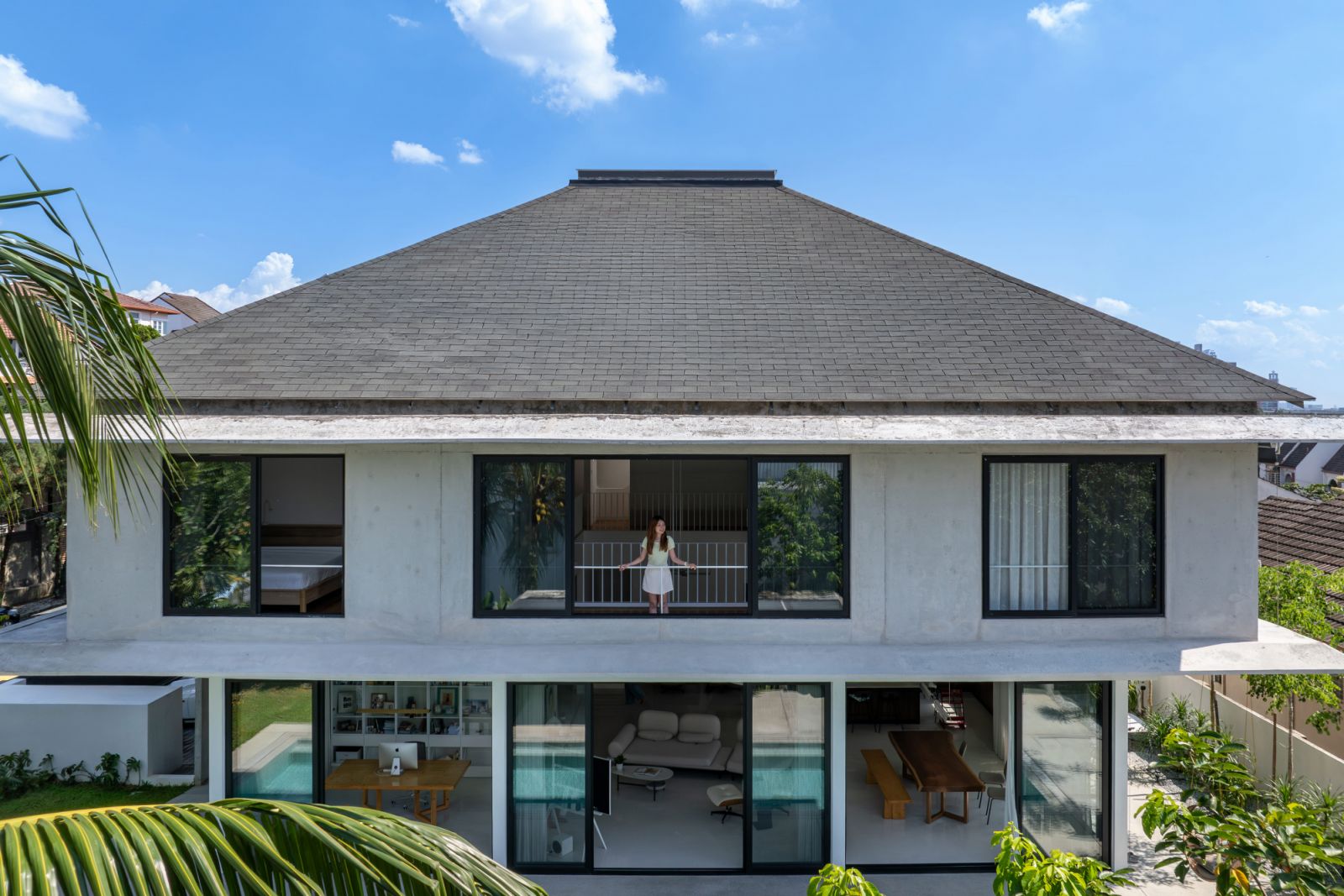 The rear elevation reveals the home's bold geometric form, with its distinctive pitched roof and floor-to-ceiling windows